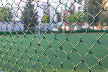 Fototapeta premium Close-up detail green color soccer area wires