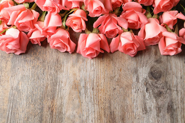 Beautiful roses on wooden table