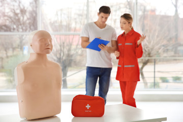 First aid mannequin on table indoors. Life saving class