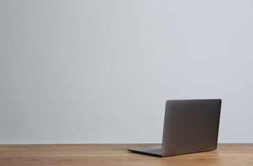 Modern laptop on table against gray background