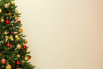 Fototapeta na wymiar Beautifully decorated Christmas tree on light background