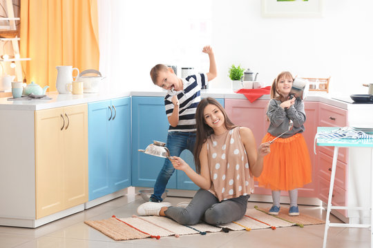 Happy family playing with kitchenware at home