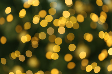Blurred view of glowing Christmas lights as background. Festive mood