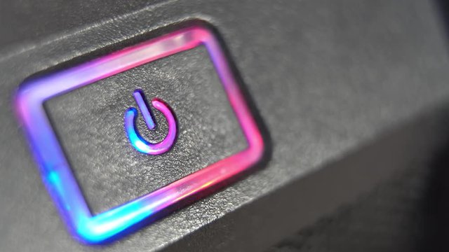 Pressing button POWER. Male finger presses computer power button. Closeup.