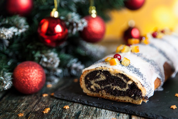 Poppy seed christmas glazed roll with candied fruits and cranberries