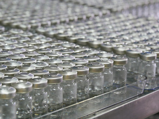 Medicine bottle for injection. Medical glass vial for vaccination. Science equipment, liquid drug or vaccine from treatment, flu in laboratory, hospital or pharmacy. Placing on the trolly .