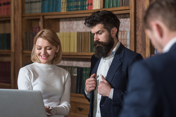 Research concept. Business people use computer technologies for making research. University students work on research in library. All the research is online