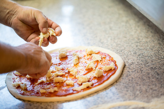 Close Up Of Hands Of A Man Making Pizza