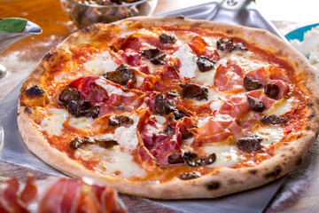 tasty close up of delicious pizza with ham, mushrooms and ricotta