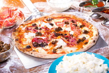 tasty close up of delicious pizza with ham, mushrooms and ricotta