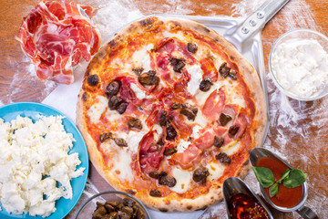 tasty close up of delicious pizza with ham, mushrooms and ricotta
