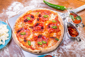 close up of tasty spicy pizza with salami and mozzarella