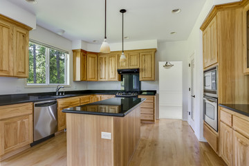 Spacious kitchen room with wooden center island.