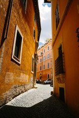 Rome city narrow street with old orange buildings