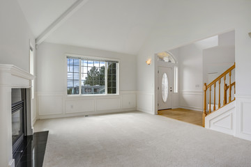White empty living room filled with sunlight.