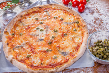 close up of delicious pizzawith anchovies and capers