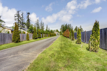 View of the road surrounded by green lawn and trees.