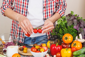Woman cooks at the kitchen