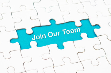 Join Our Team texts with white jigsaw puzzle board.