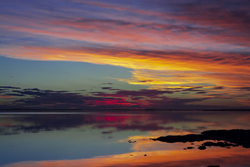 Fototapeta na wymiar Colorful sunset on the lakeshore in Carhue, Argentina