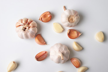 Modern art of garlic with segments isolated on white background.