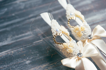 Wedding glasses close-up on a gray shabby wooden background