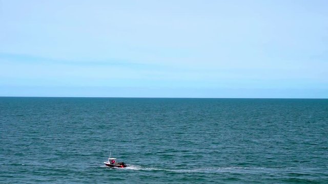 Boat Cruising Along the Coastline