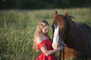 girl in a red dress with a horse