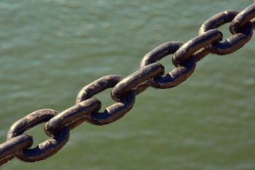 thick steel black chain on the background of the sea