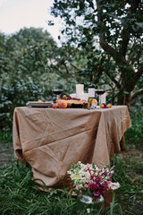 served table in garden, bouquet of flowers on grass