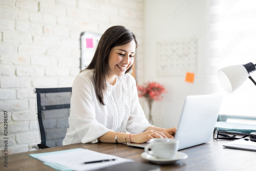 Wall mural enjoying working at her desk