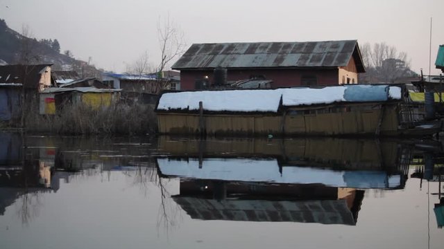 Scenes from Dal Lake in Kashmir, India. Boats on the lake, people, and culture. Boats are called shikaras. Sunset, documentary feel.