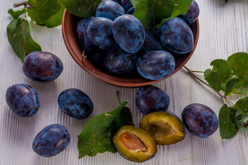 Fresh plums in bowl