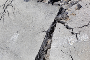 Broken asphalt road surface