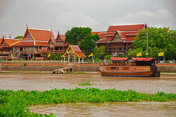 Thai Wooden Restaurant Boat On Ayutthaya River Tourists cruise the Chao Phraya River to visit ancient temples of Thailand. In Phra Nakhon Si Ayutthaya - obrazy, fototapety, plakaty
