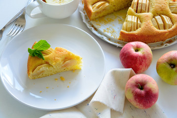 Slice of homemade apple pie on white plate. Tea time concept