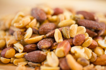 Background of nuts - pecan, macadamia, brazil nut, walnut, almonds, hazelnuts, pistachios, cashews, peanuts, pine nuts - with copy space. Isolated one edge. Top view or flat lay