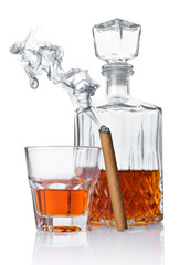 Strong alcoholic drink cognac in old fashion glass and crystal decanter with smoking cigar