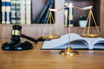 Scales of justice and Gavel on sounding block and law book to working with judge agreement in...