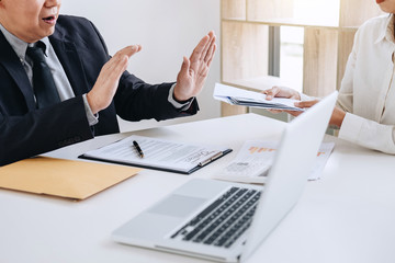Fototapeta premium Bribery and corruption concept, senior businessman manager refusing receive money in the envelope to agreement contract, A bribe in the form of dollar bills