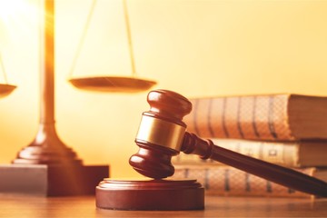 Books and wooden gavel on table