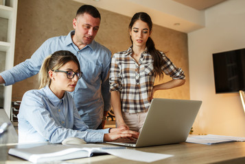 Group of office  workers using computer and discuss about business project.Teamwork concept.