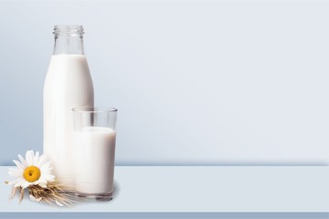 Glass of milk and bottle on  background