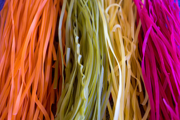 Colored Raw Vegetable Vegetarian Pasta with Beets, Carrots and Spinach. Flat lay. Copy space. Top view. Frame.
