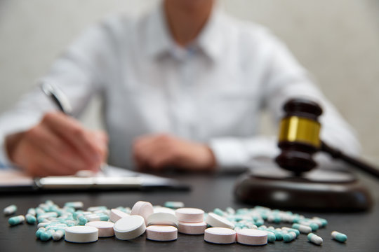 Medicine law concept. Judges gavel with pills