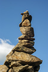 Fototapeta na wymiar balanced tower of wild stones against the sky