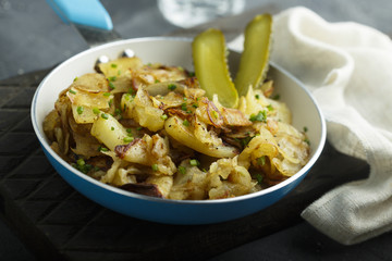 Fried potato with pickled cucumber