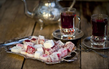 traditional Turkish or Asian tea, tea with lukum, oriental sweets of lukum