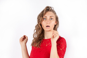 Portrait of a young scared woman in a red dress