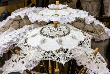 Lacy white umbrellas - traditional souvenires in Burano island, Venice, Italy